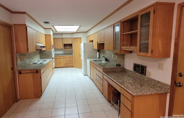 kitchen with sink, crown molding, light tile patterned floors, tasteful backsplash, and a textured ceiling