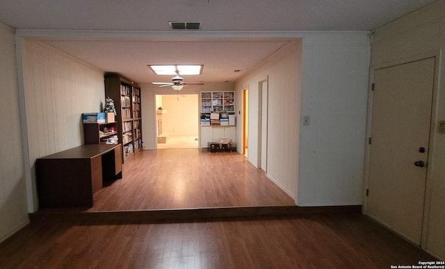 corridor featuring crown molding and hardwood / wood-style floors