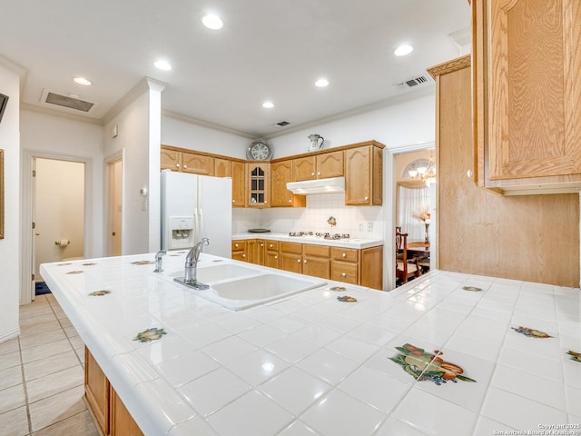 kitchen featuring sink, white appliances, light tile patterned floors, tile counters, and decorative backsplash