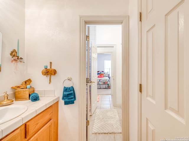 bathroom featuring tile patterned flooring and vanity