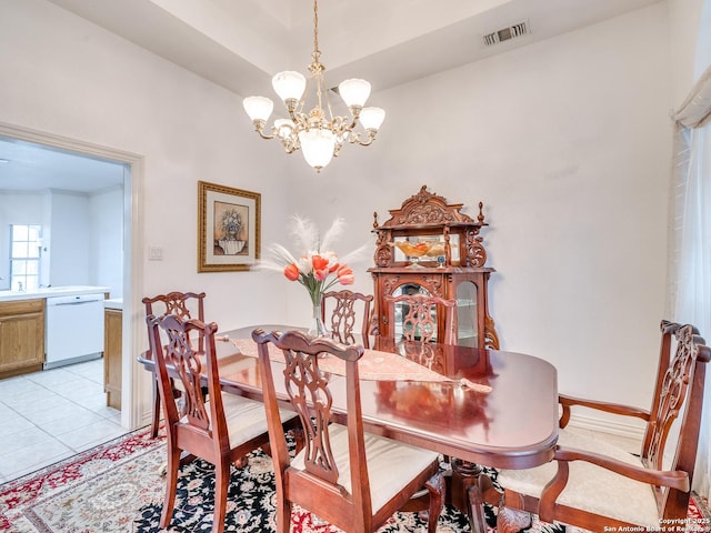 tiled dining space featuring a chandelier