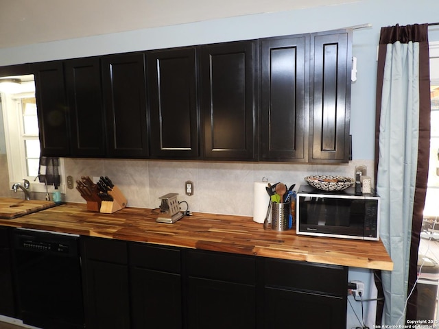 kitchen with butcher block counters, a wealth of natural light, and black appliances