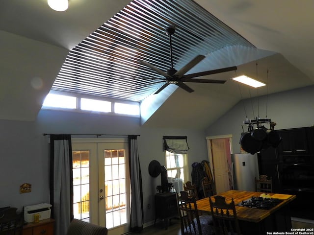 dining space featuring lofted ceiling, french doors, and ceiling fan