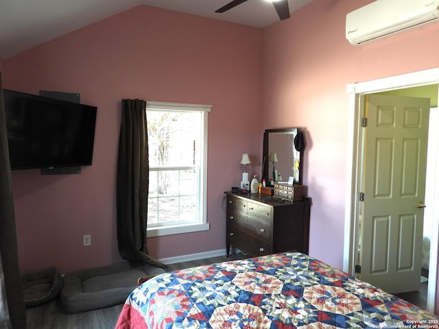 bedroom featuring wood-type flooring, a wall mounted AC, and vaulted ceiling