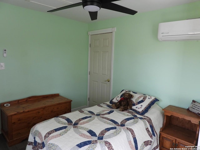 bedroom featuring ceiling fan and a wall unit AC