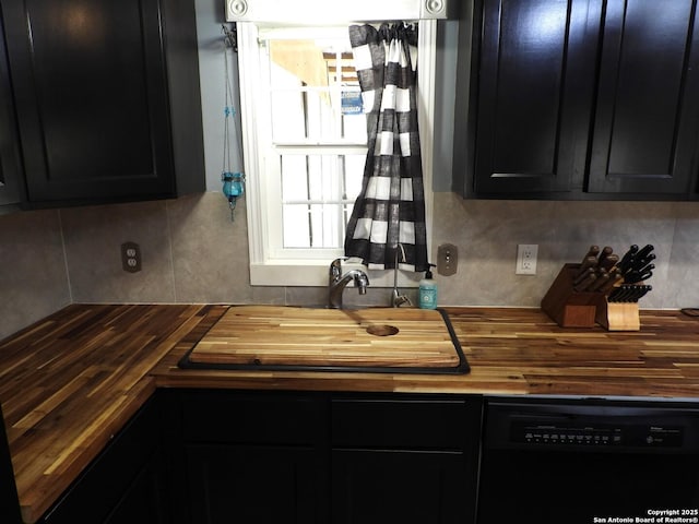 kitchen featuring dishwasher, butcher block counters, sink, and backsplash