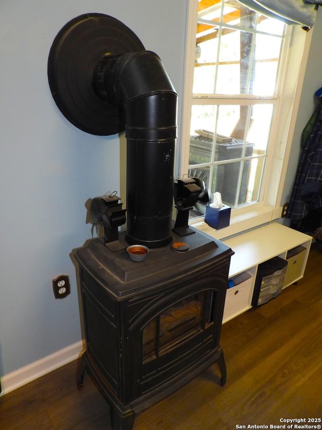 room details featuring wood-type flooring and a wood stove