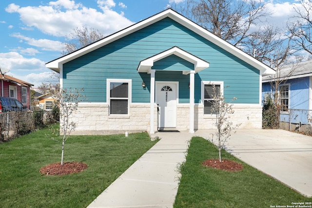 bungalow-style home featuring a front yard