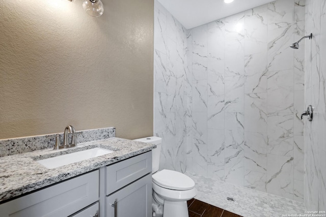 4423 Buena Vista St, San Antonio, TX 78237 - bathroom featuring vanity, toilet, wood-type flooring, and a tile shower