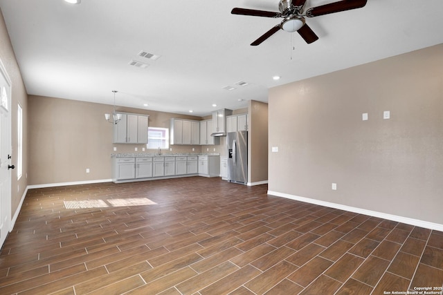 4423 Buena Vista St, San Antonio, TX 78237 - unfurnished living room with sink and ceiling fan with notable chandelier