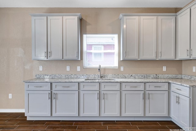 4423 Buena Vista St, San Antonio, TX 78237 - kitchen featuring sink, light stone countertops, and white cabinets
