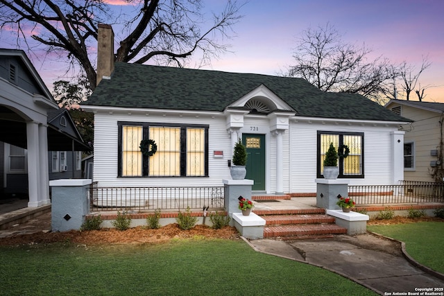 view of front facade with a yard and a porch