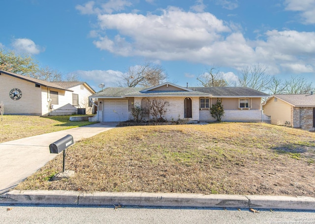 single story home with a garage and a front lawn