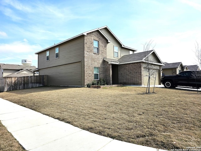 view of side of home with a garage, brick siding, a lawn, and fence