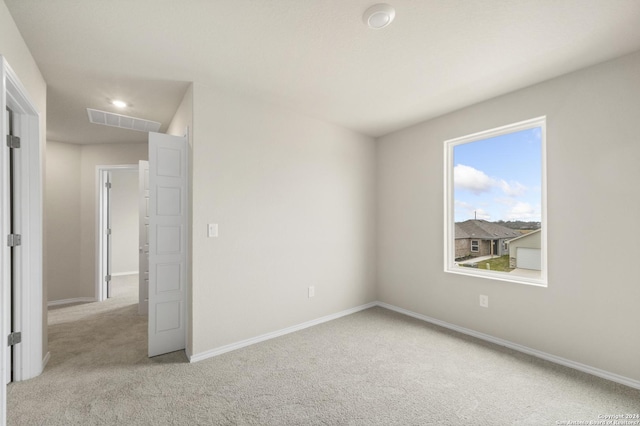 unfurnished bedroom featuring light carpet