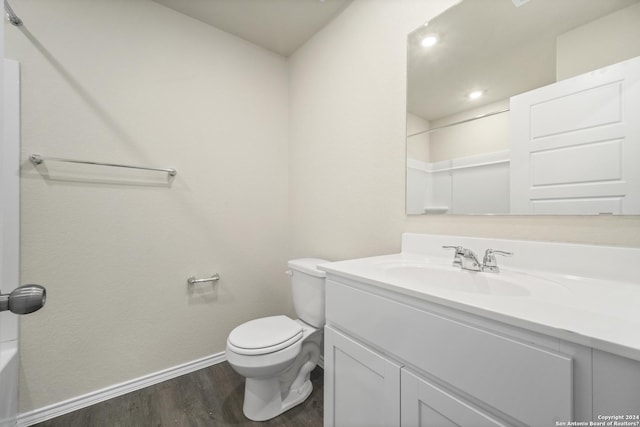 bathroom featuring a shower, hardwood / wood-style floors, vanity, and toilet