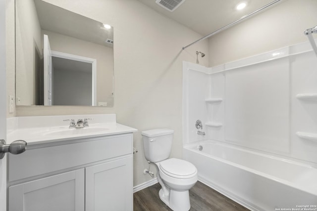 full bathroom with shower / bathing tub combination, hardwood / wood-style floors, vanity, and toilet