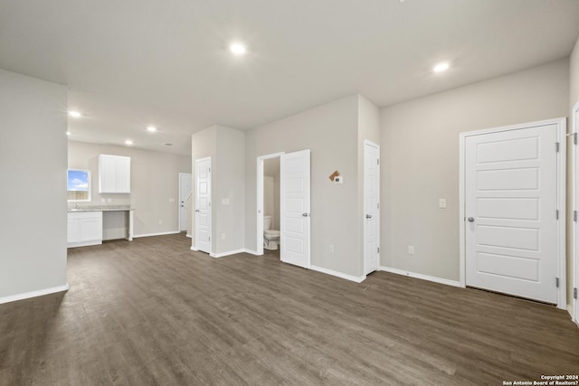 unfurnished living room featuring dark wood-type flooring