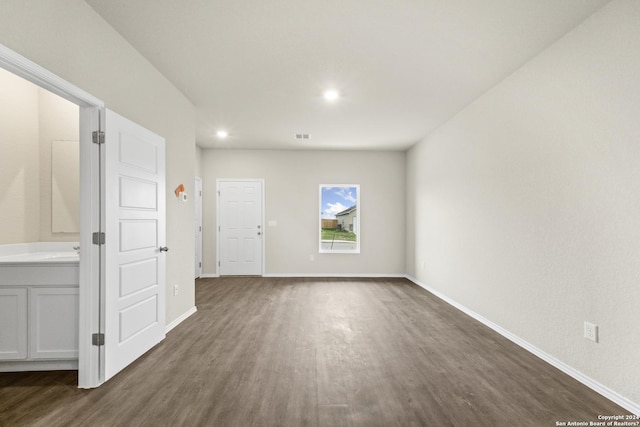 spare room with dark hardwood / wood-style floors