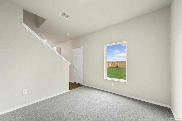 unfurnished room featuring dark carpet