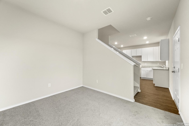 unfurnished living room featuring dark colored carpet