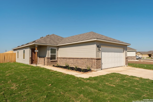 view of front of house with a garage and a front lawn