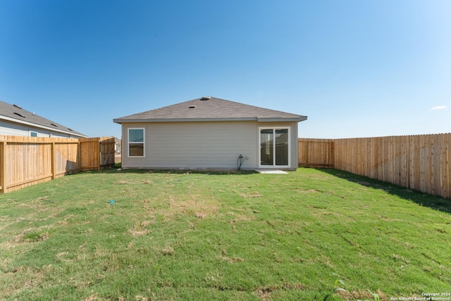 back of house with a yard