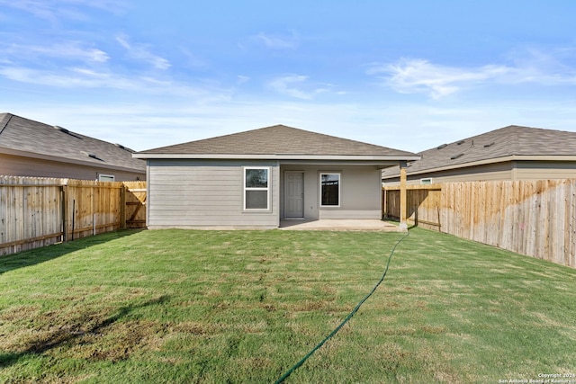 rear view of house featuring a yard and a patio area