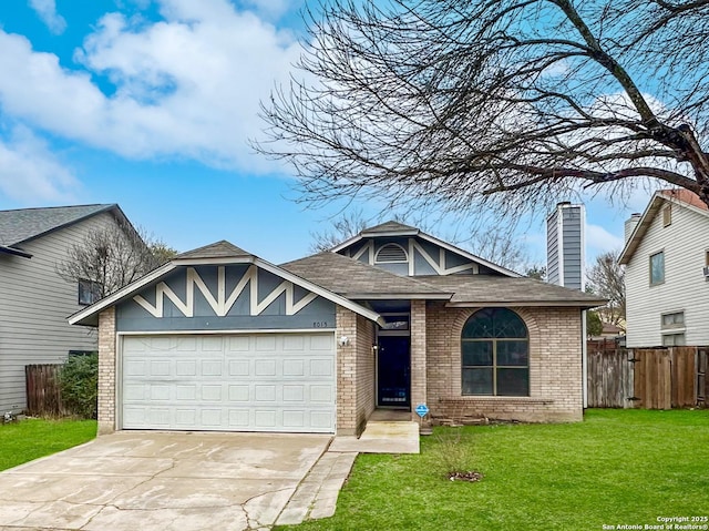 view of front of property featuring a garage and a front lawn