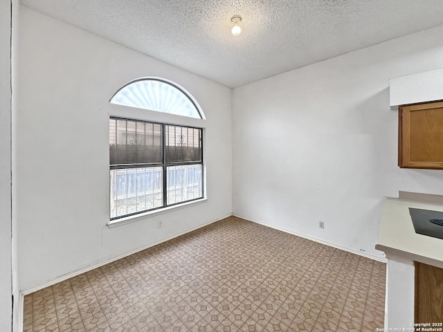 unfurnished room featuring a textured ceiling