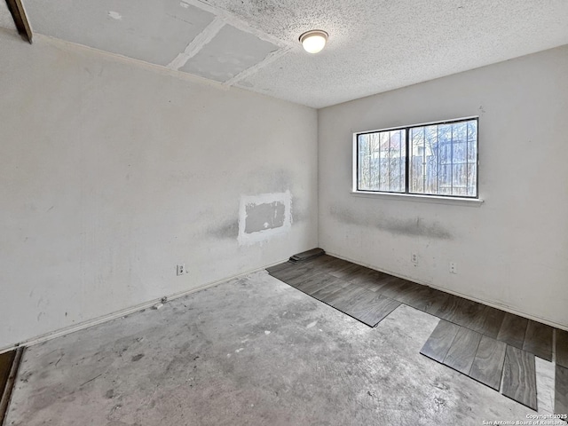 spare room with a textured ceiling