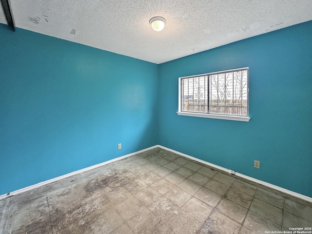 spare room featuring a textured ceiling