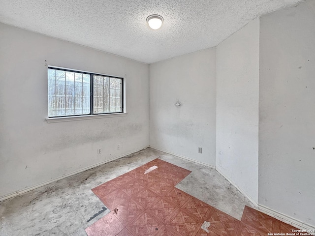 spare room featuring a textured ceiling