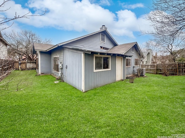 back of property featuring a lawn