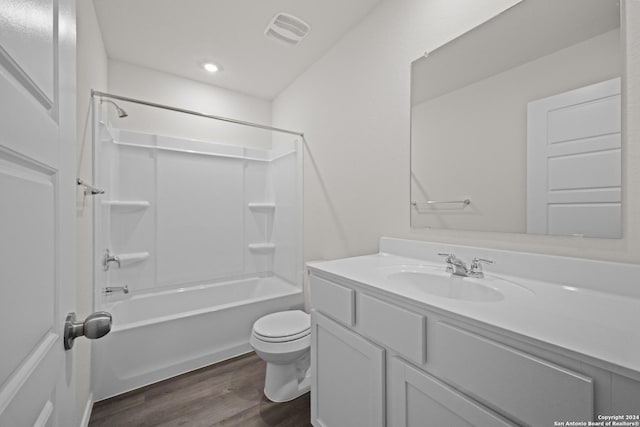 full bathroom with hardwood / wood-style floors, toilet, vanity, and tub / shower combination