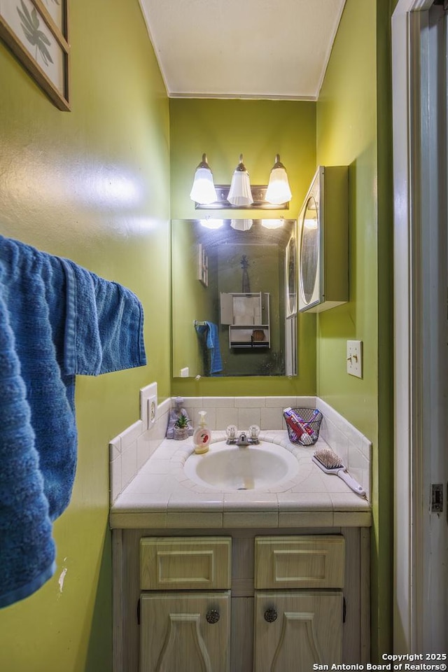 bathroom with vanity and crown molding