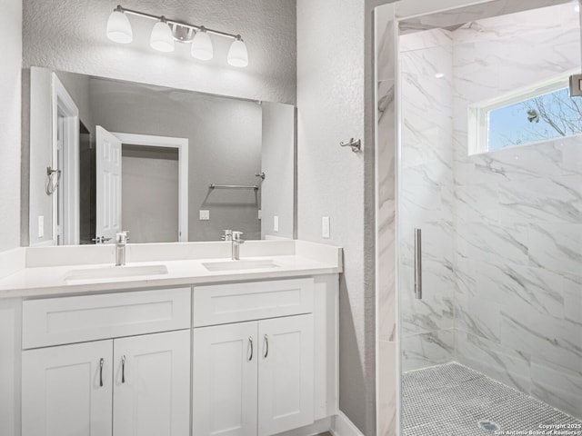 bathroom with a shower with door and vanity