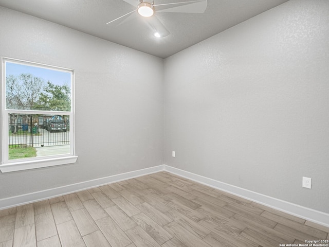 empty room with light hardwood / wood-style floors and ceiling fan