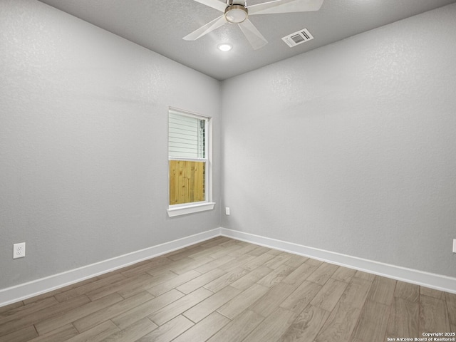 empty room featuring ceiling fan and light hardwood / wood-style flooring