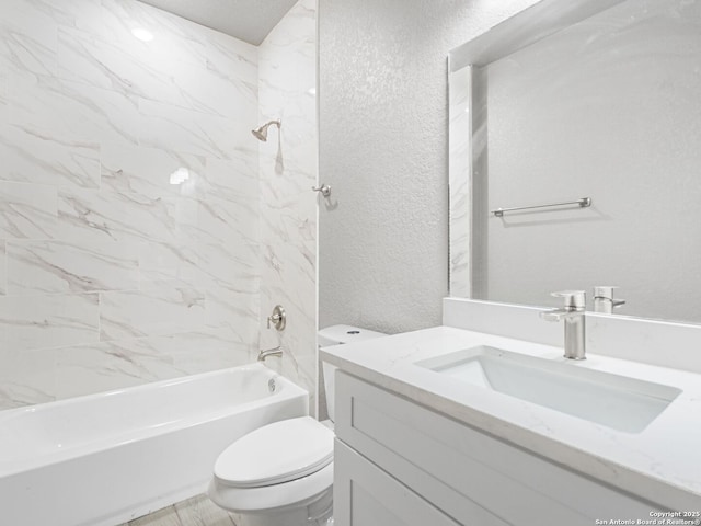 full bathroom featuring toilet, vanity, and tiled shower / bath combo