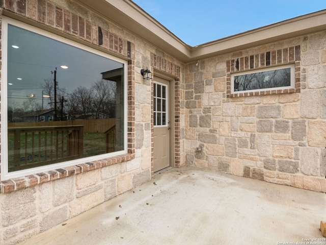 entrance to property featuring a patio area