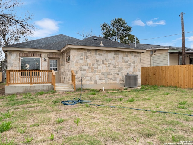 rear view of house featuring a yard and cooling unit