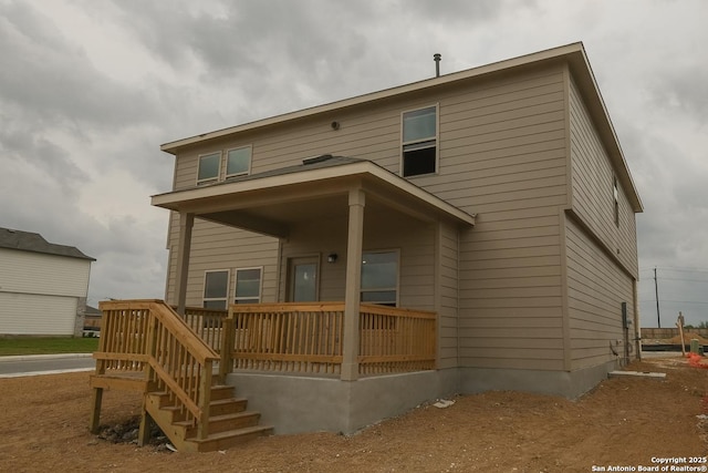rear view of property with a porch