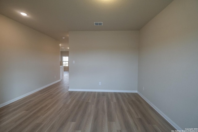 8409 Roadrunner Psge, San Antonio, TX 78222 - unfurnished room featuring wood finished floors and recessed lighting