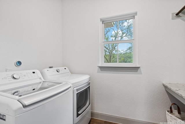 washroom with separate washer and dryer and dark hardwood / wood-style floors