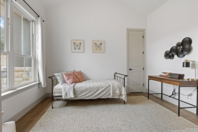 bedroom featuring vaulted ceiling and light hardwood / wood-style floors