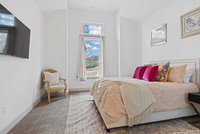 carpeted bedroom with vaulted ceiling