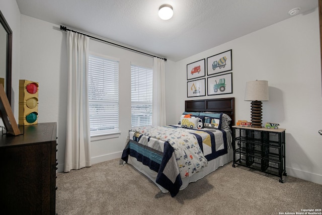 bedroom featuring light carpet and a textured ceiling