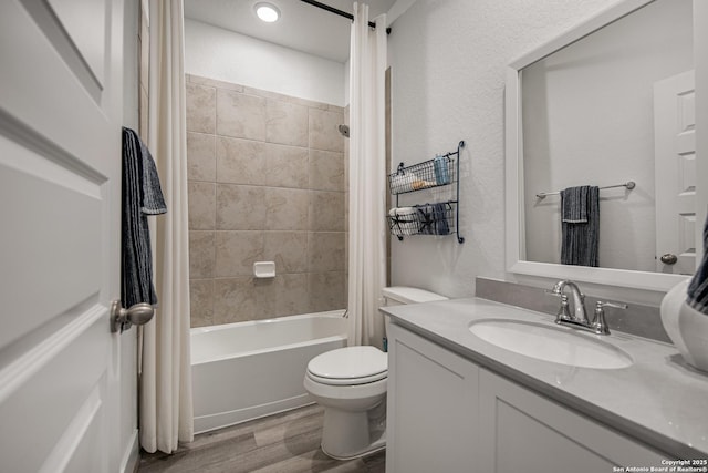 full bathroom featuring shower / tub combo, vanity, hardwood / wood-style floors, and toilet