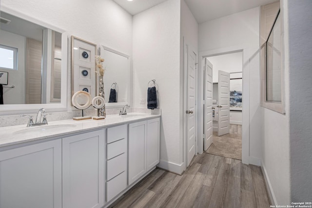 bathroom with vanity and hardwood / wood-style floors